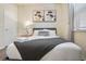 Simple bedroom with a double bed and nightstand, near a door at 8896 Bengal Ct, Kissimmee, FL 34747