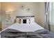 Bedroom with gray bed, white dresser, and decorative wall art at 8896 Bengal Ct, Kissimmee, FL 34747