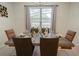 Modern dining room featuring a wood table, six chairs, and large window at 8896 Bengal Ct, Kissimmee, FL 34747