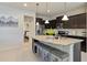 Modern kitchen with dark brown cabinets, granite countertops, and an island at 8896 Bengal Ct, Kissimmee, FL 34747