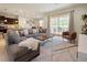 Spacious living room with gray sectional sofa, large TV, and access to a patio at 8896 Bengal Ct, Kissimmee, FL 34747