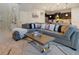 Open-concept living room with a gray sectional sofa and kitchen views at 8896 Bengal Ct, Kissimmee, FL 34747