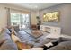 Open living area with gray sectional sofa and backyard access at 8896 Bengal Ct, Kissimmee, FL 34747