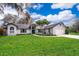 Ranch-style home with lush green landscaping at 9012 Ogilvie Dr, Orlando, FL 32819