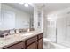 Clean bathroom with a large shower and granite vanity at 9024 Shadow Mountain St, Davenport, FL 33896