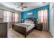 Bright bedroom with a king bed and blue accent wall at 9024 Shadow Mountain St, Davenport, FL 33896