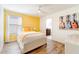 Charming bedroom with a queen-size bed and yellow accent wall at 9024 Shadow Mountain St, Davenport, FL 33896