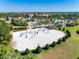 Aerial view of community pool area with volleyball court and residents enjoying the amenities at 9024 Shadow Mountain St, Davenport, FL 33896