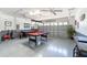 Fun game room with pool table, air hockey, and game accents at 9024 Shadow Mountain St, Davenport, FL 33896