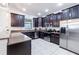 Modern kitchen with dark wood cabinets and stainless steel appliances at 9024 Shadow Mountain St, Davenport, FL 33896