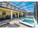 Resort-style pool and spa with screened patio and seating at 9024 Shadow Mountain St, Davenport, FL 33896