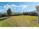 Spacious backyard with grassy lawn, privacy fence, and partial view of house at 9459 Jaywood Rd, Winter Garden, FL 34787