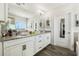 Elegant bathroom with double vanity, granite countertop, and large mirror at 9459 Jaywood Rd, Winter Garden, FL 34787