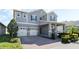 Two-story home with gray siding, two-car garage, and landscaped yard at 9459 Jaywood Rd, Winter Garden, FL 34787