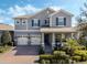 Two-story home with gray siding, two-car garage, and landscaped yard at 9459 Jaywood Rd, Winter Garden, FL 34787