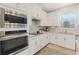 Modern kitchen with stainless steel appliances and white cabinets at 9459 Jaywood Rd, Winter Garden, FL 34787