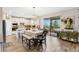 Kitchen with white cabinets, kitchen island, and dining area at 9459 Jaywood Rd, Winter Garden, FL 34787