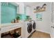 Convenient laundry room with washer, dryer, and stylish tile at 9459 Jaywood Rd, Winter Garden, FL 34787