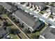 Aerial view of a neighborhood featuring townhomes with manicured landscaping and driveways at 1044 Pavia Dr, Apopka, FL 32703