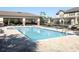 A community pool with lounge seating, tables, and shaded cabana at 1044 Pavia Dr, Apopka, FL 32703