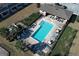 Overhead view of a community pool with lounge chairs and tables near neighboring townhomes at 1044 Pavia Dr, Apopka, FL 32703