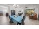 Dining area with light teal tablecloth, chandelier, and hardwood floors at 1069 Avery Meadows Way, Deland, FL 32724