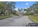 Community entrance with guard house and lush landscaping at 1069 Avery Meadows Way, Deland, FL 32724