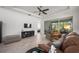 Spacious living room with hardwood floors, comfortable seating, and access to the back porch at 1069 Avery Meadows Way, Deland, FL 32724