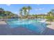 Resort-style pool with palm trees and shaded seating at 1069 Avery Meadows Way, Deland, FL 32724