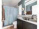 Bathroom with tiled shower, modern fixtures, and a stylish vanity and decor at 11148 Einbender Rd, Orlando, FL 32825