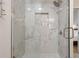 Bright shower with marble-like wall tiles and glass enclosure at 11626 Graces Way, Clermont, FL 34711