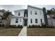 Two-story modern home with gray and white exterior, landscaping, and walkway at 1178 Drop Ln, Kissimmee, FL 34747
