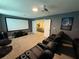 Home theater with projector, screen, and comfortable seating at 1178 Drop Ln, Kissimmee, FL 34747