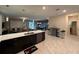 Modern kitchen with island, stainless steel appliances, and view to living room at 1178 Drop Ln, Kissimmee, FL 34747