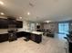 Open concept kitchen with island, stainless steel appliances, and view to living area at 1178 Drop Ln, Kissimmee, FL 34747