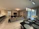 Open concept living and dining area with sectional sofa and access to backyard at 1178 Drop Ln, Kissimmee, FL 34747