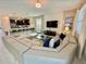Open concept living room with large sectional sofa, kitchen, and dining area visible at 1178 Drop Ln, Kissimmee, FL 34747