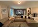 Spacious living room with large sectional sofa, dining area, and view to backyard at 1178 Drop Ln, Kissimmee, FL 34747