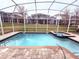 Inviting pool and spa with screened enclosure at 1178 Drop Ln, Davenport, FL 33896