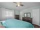 Bedroom with king-size bed, dresser, and ceiling fan at 1201 Carol Ave, Auburndale, FL 33823