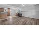 Open living area with wood-look floors and a view of the kitchen at 1201 Carol Ave, Auburndale, FL 33823