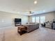 Open living room featuring neutral carpet, large gray couch, and lots of natural light from the windows at 13870 Jomatt Loop, Winter Garden, FL 34787