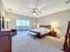 Main bedroom featuring carpet, a ceiling fan, and a sliding glass door leading to the exterior at 13870 Jomatt Loop, Winter Garden, FL 34787