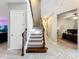 Carpeted staircase with wood and iron railings, leading to the upper level of the home at 13870 Jomatt Loop, Winter Garden, FL 34787