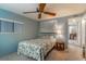 Cozy bedroom with floral bedding, ceiling fan, and window coverings at 151 E Plantation Blvd, Lake Mary, FL 32746
