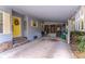 Covered carport with concrete flooring and yellow front door at 151 E Plantation Blvd, Lake Mary, FL 32746