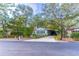 Light blue manufactured home with a long driveway and street view at 151 E Plantation Blvd, Lake Mary, FL 32746
