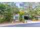 Blue manufactured home on a tree-lined street with a white bench at 151 E Plantation Blvd, Lake Mary, FL 32746