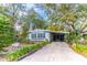Quaint light blue manufactured home nestled in a wooded area with a flag at 151 E Plantation Blvd, Lake Mary, FL 32746