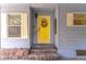 Bright yellow front door with wreath and stone steps at 151 E Plantation Blvd, Lake Mary, FL 32746